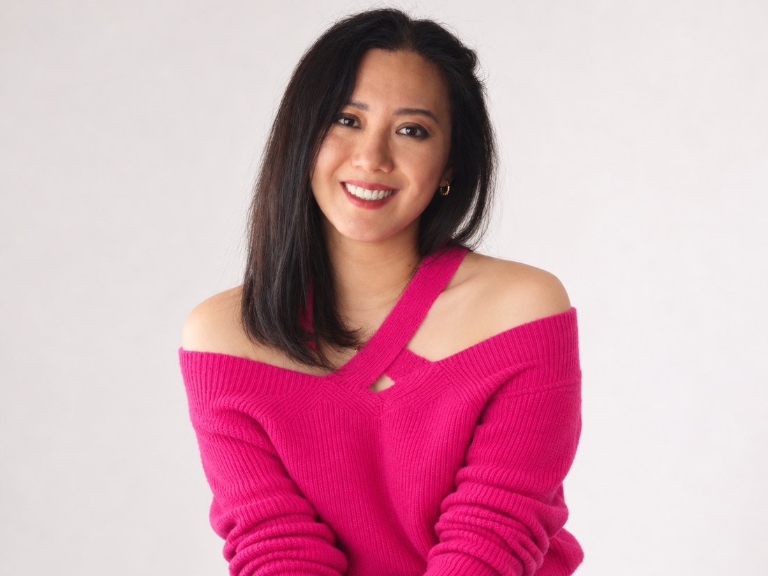 Liya Bergen smiling in a pink jumper